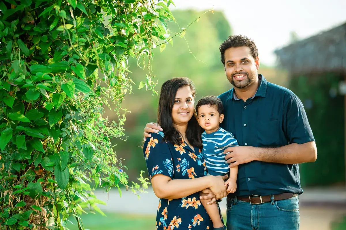 Parents and child sharing a playful outdoor moment
