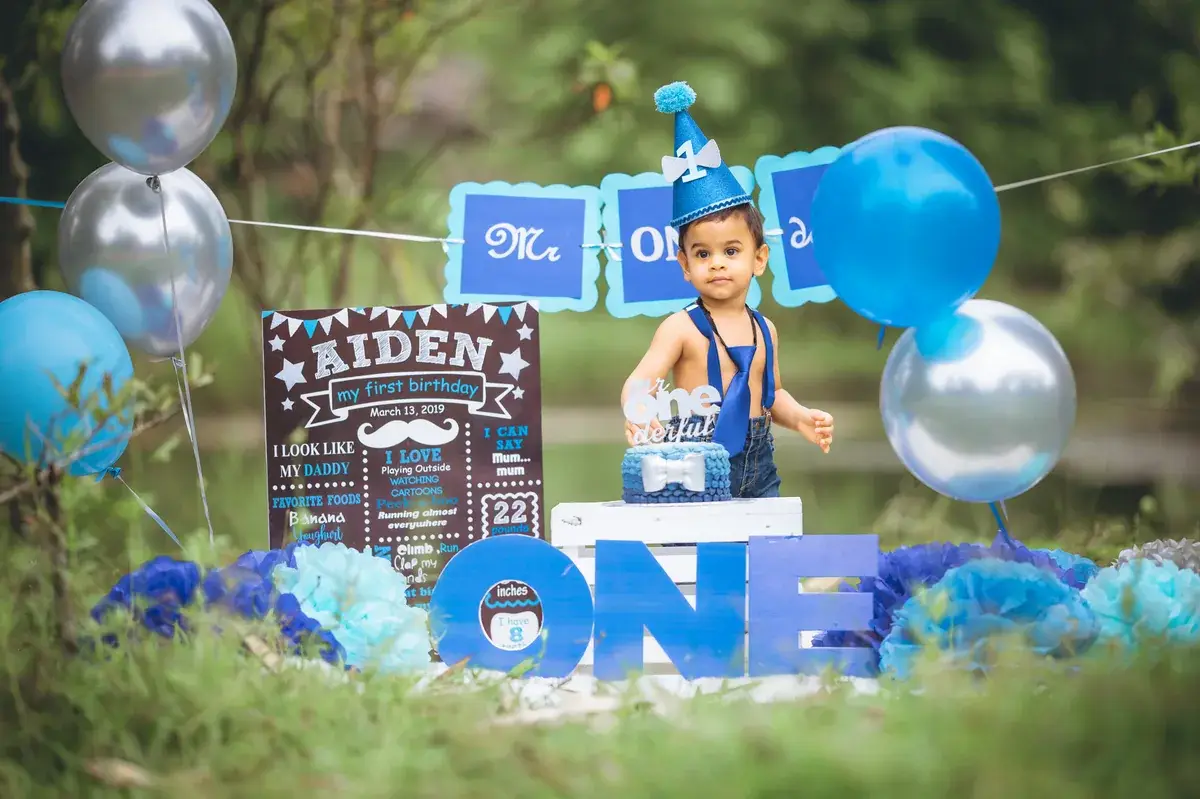 First birthday portrait with a blue cake-smash setup