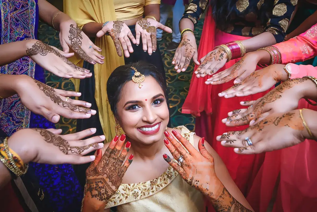 Mehndi bride surrounded by decorated hands