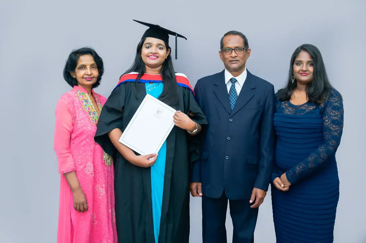 Graduate with family in a formal studio portrait