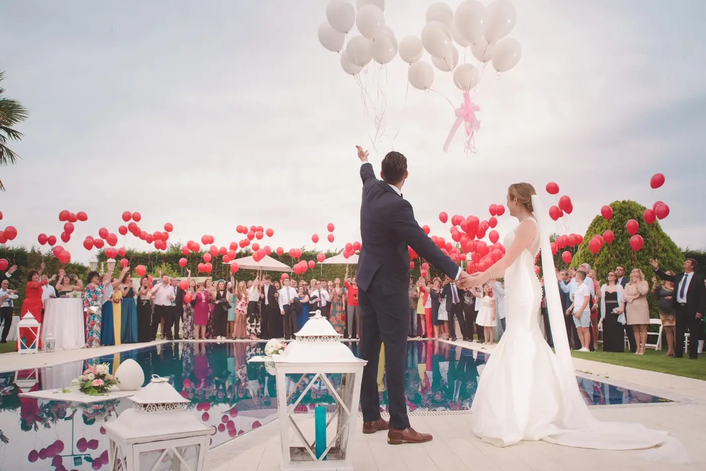 Newly married couple celebrating with guests and balloons