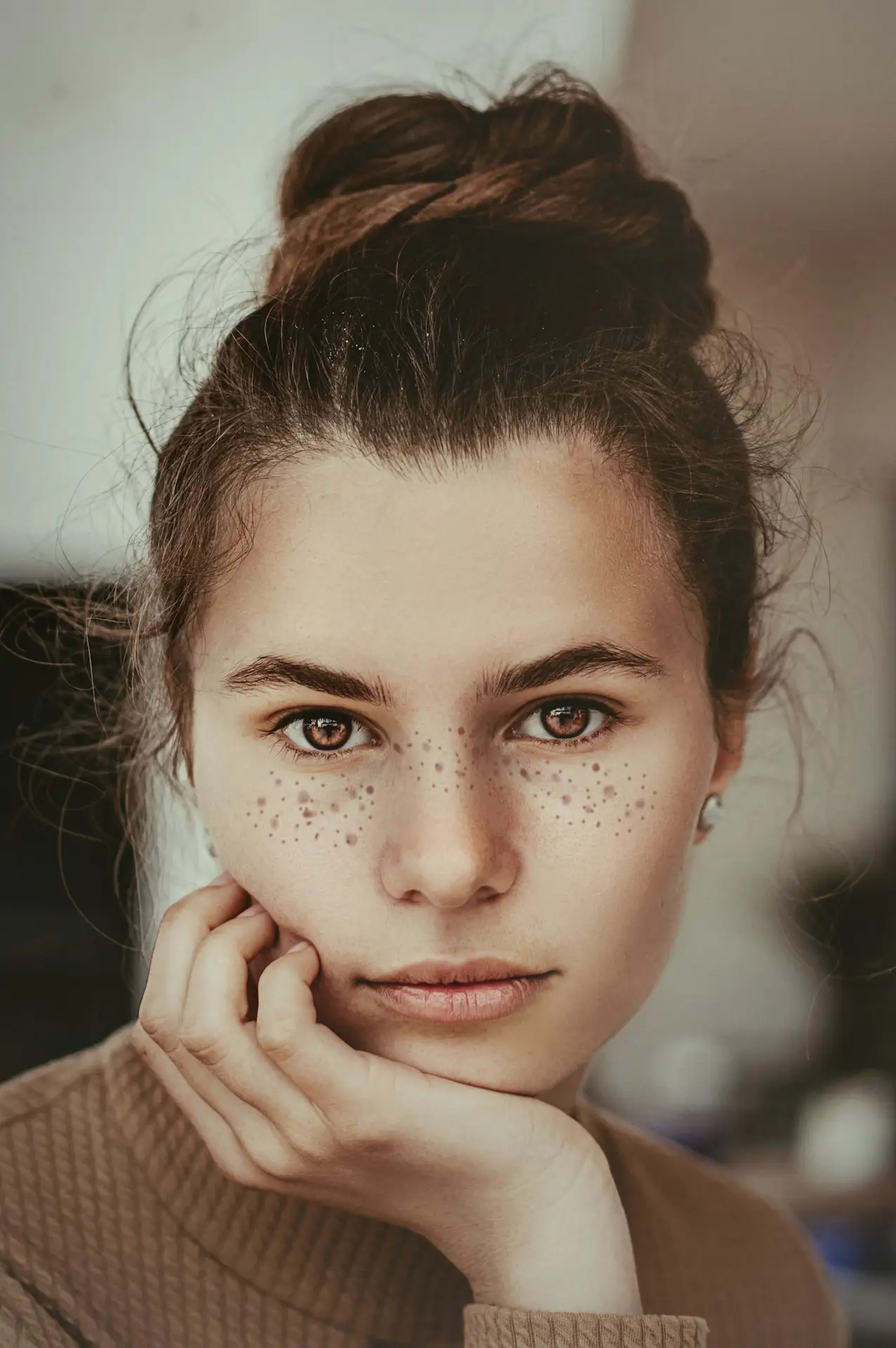 Close portrait of a woman with freckles looking at the camera